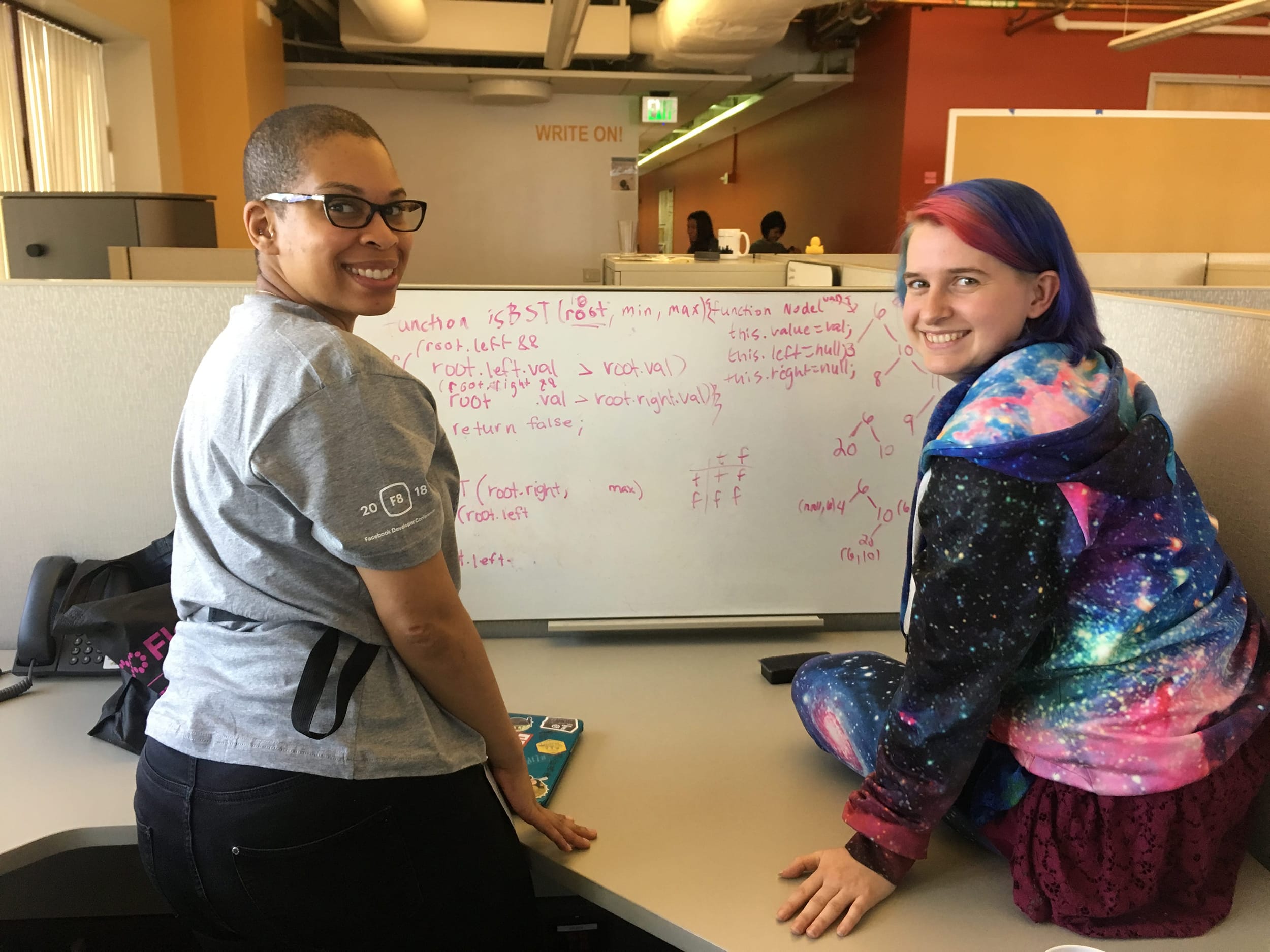 Two people practicing whiteboarding.